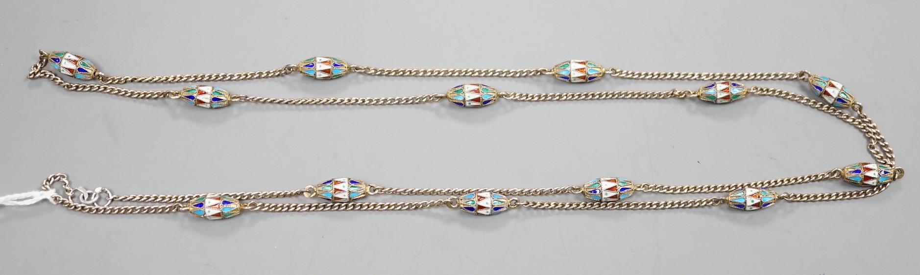 An early 20th century Russian 84 zolotnik and polychrome cloisonné enamel necklace, set with thirteen torpedo shaped enamelled links, 94cm.
